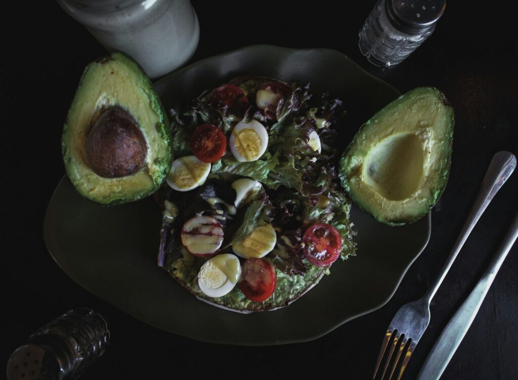 Eggs, avocado and fresh salad on a plate