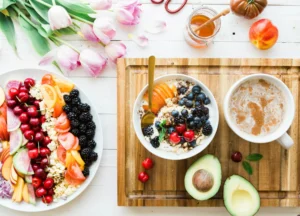 Yoghurt with fresh fruit and a cup of coffee on a table