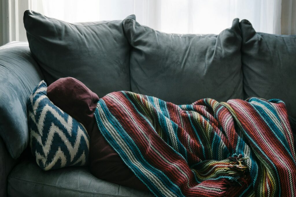 Someone resting on a sofa at home
