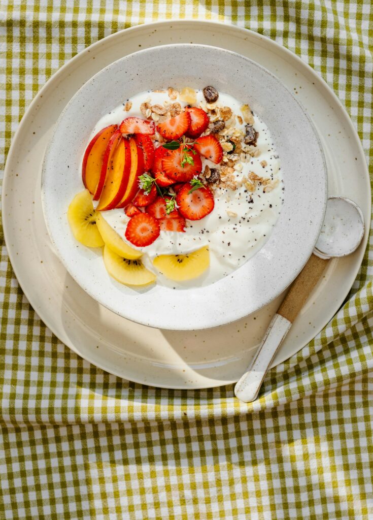 A bowl of yoghurt topped with fruit